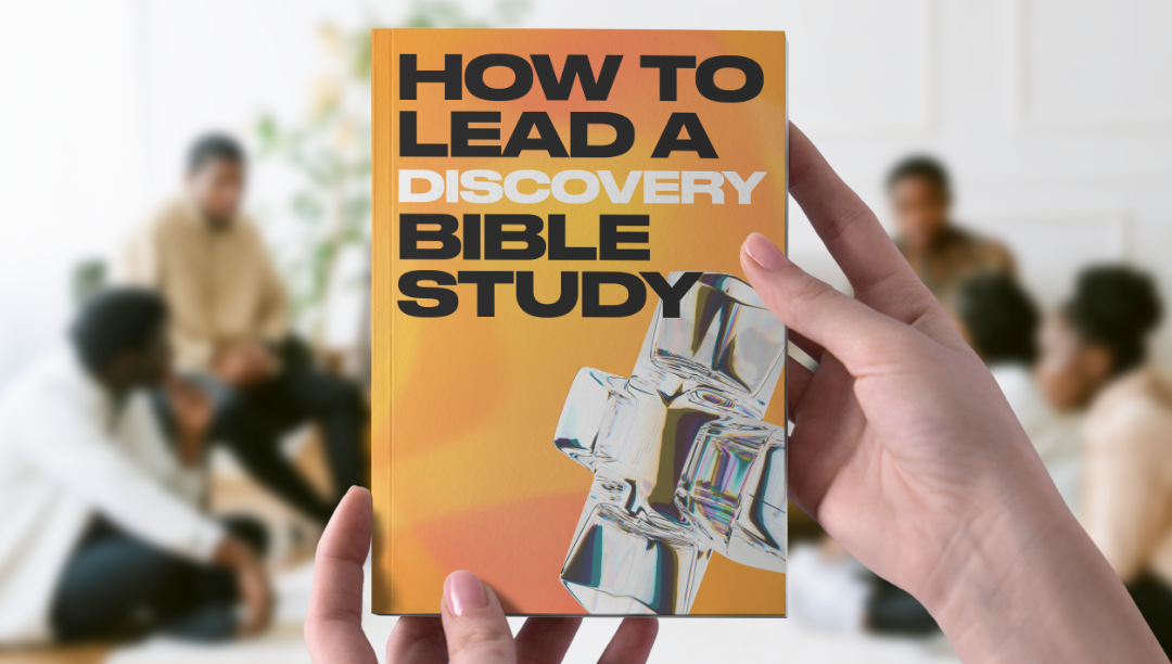 hands holding a book at a bible study that says "how to lead a discovery bible study"