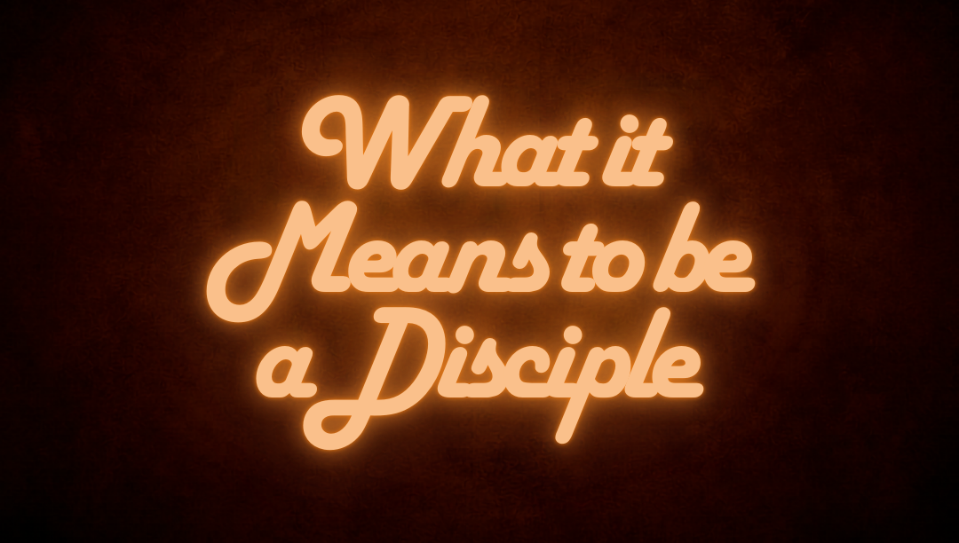 dark background with faux neon text that says "What it means to be a disciple"
